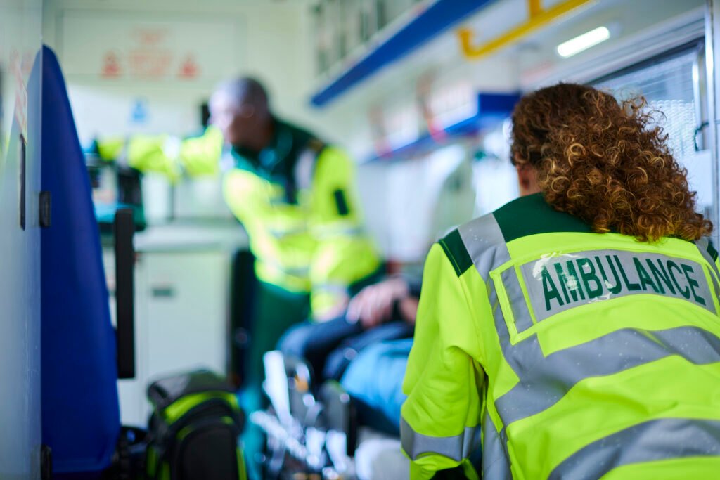 ambulance paramedics with casualty inside ambulance